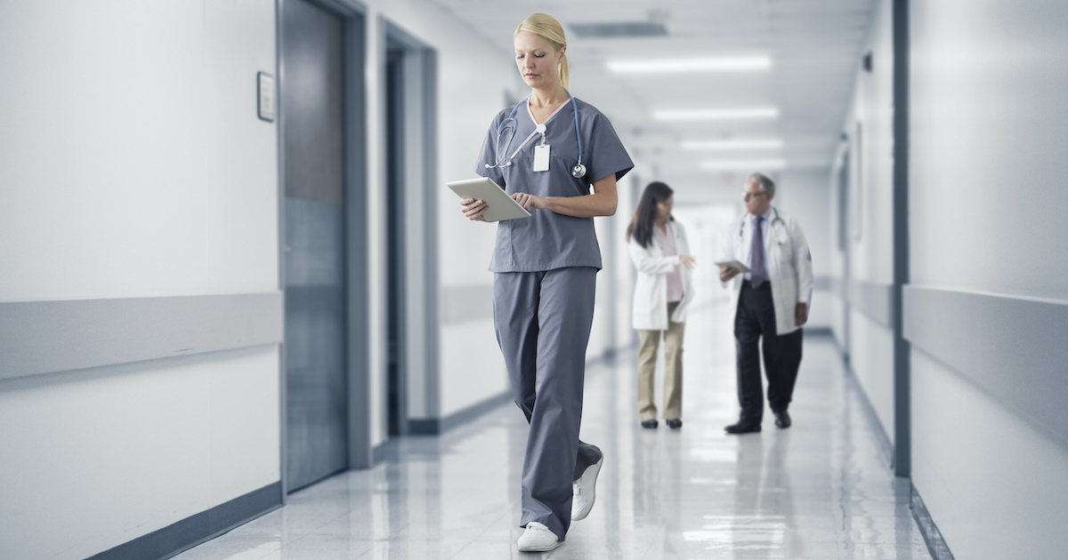 A nurse checking a patient's chart on a digital tablet