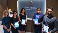 Representatives of NTU Singapore spin-off Gray Matter Solutions and Osler Group showing the application-based early dementia detection tool