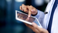 Clinician looking at a tablet computer
