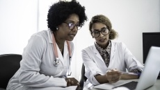 Healthcare professionals reviewing data on a labtop 