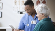 Health care team member reviewing medical history with patient