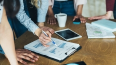 Workers reviewing and analyzing data