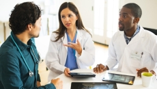 Healthcare professionals reviewing and discussing clinical data