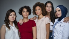 Five people standing in a group looking at the camera