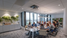 people sitting around glass table talking about business.