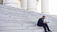 Man sitting on court building steps