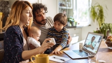 Family communicating with healthcare professional via telehealth