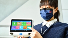 A staff from Foxconn demonstrating a digital medical device