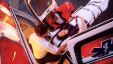 Paramedics rolling a patient onto an ambulance.