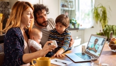 A family talking to a doctor on a laptop
