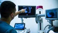 doctor conducting a mammogram