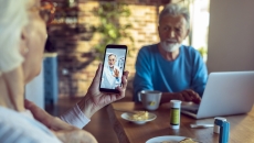 A couple talking on a smartphone telehealth visit