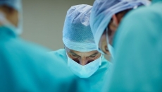 A close up of surgeons working in an operating room.