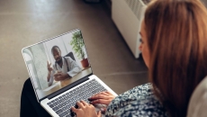A woman talking to a doctor via telehealth
