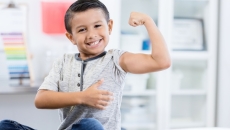 Person sitting in a clinic while flexing their arm muscles