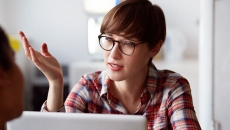 Person wearing glasses and sitting in front of a computer