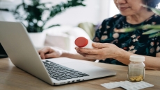 A woman looking up prescription prices online