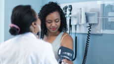 A provider checking blood pressure during an appointment