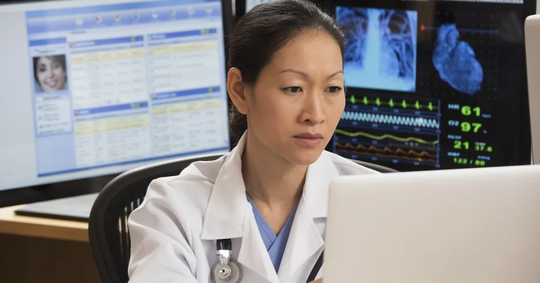 Healthcare technician reviewing MRI data