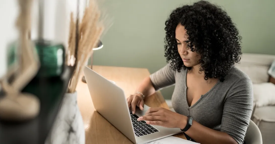 A woman doing research on a laptop computer