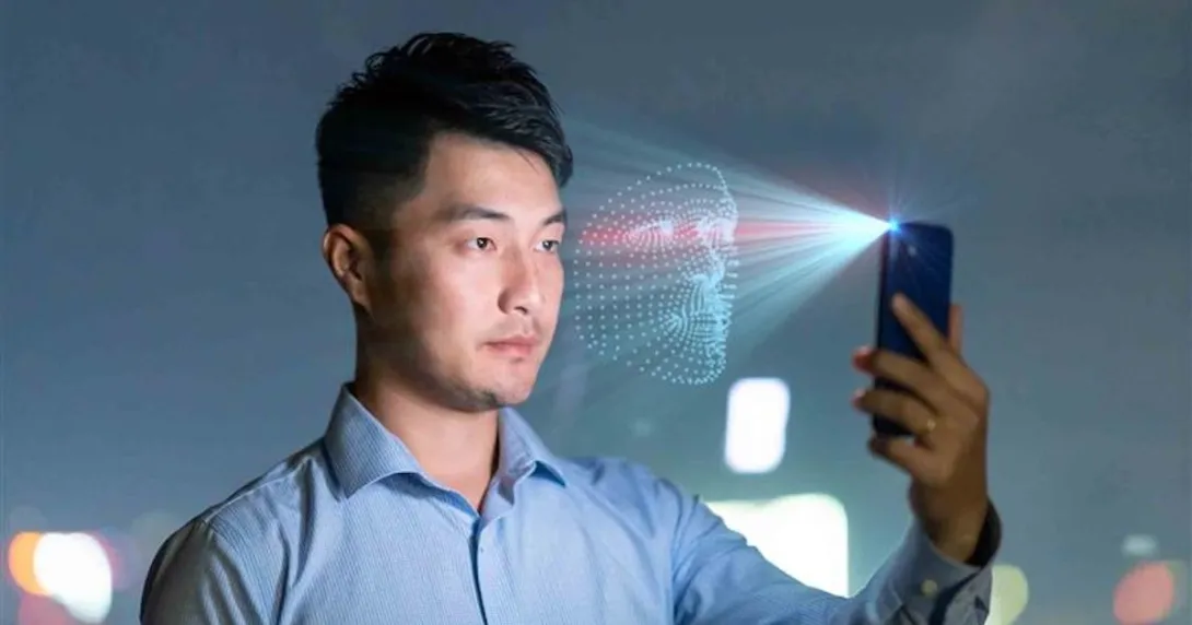 Person holding a phone while it scans their face