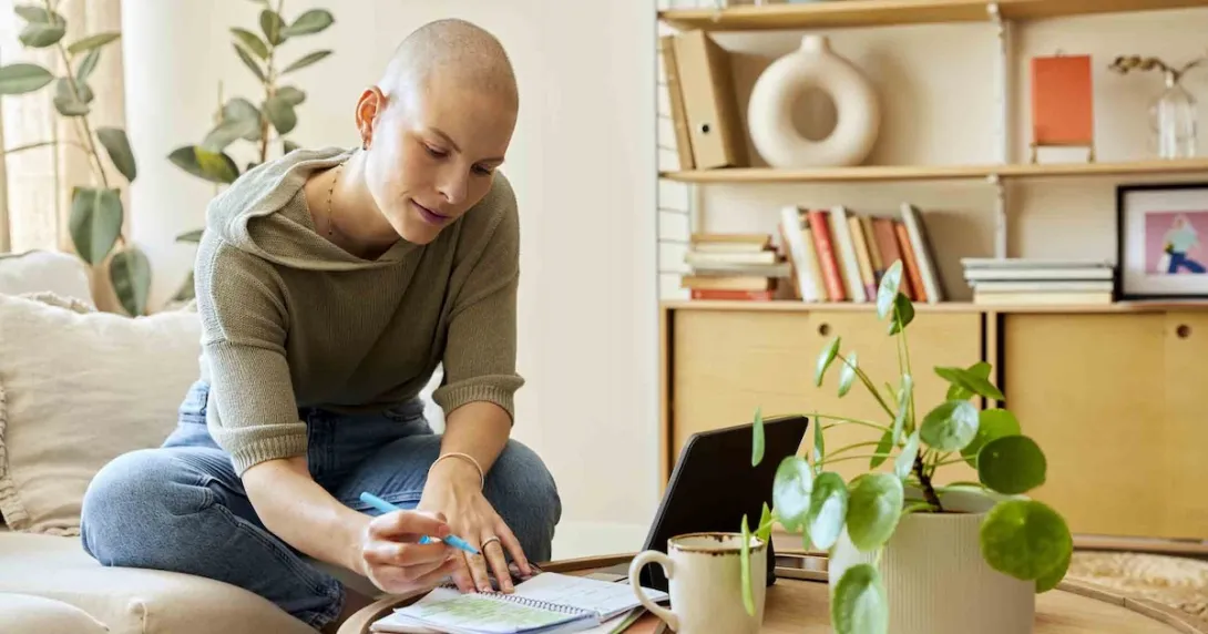 Person sitting in a home while looking at a laptop