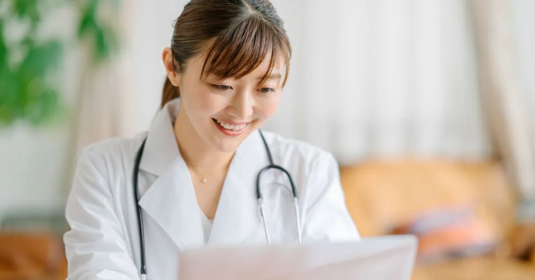 A doctor looking up a patient's data on a laptop computer