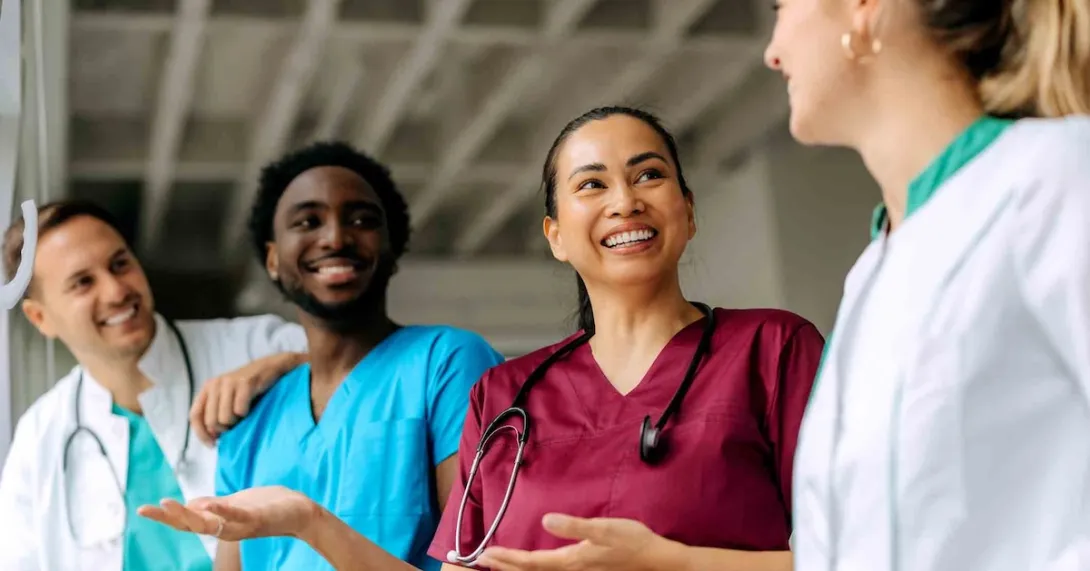 Group of healthcare providers standing in a circle and talking