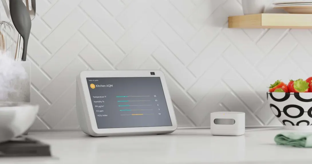 Amazon's air quality monitor next to an Alexa device displaying quality metrics