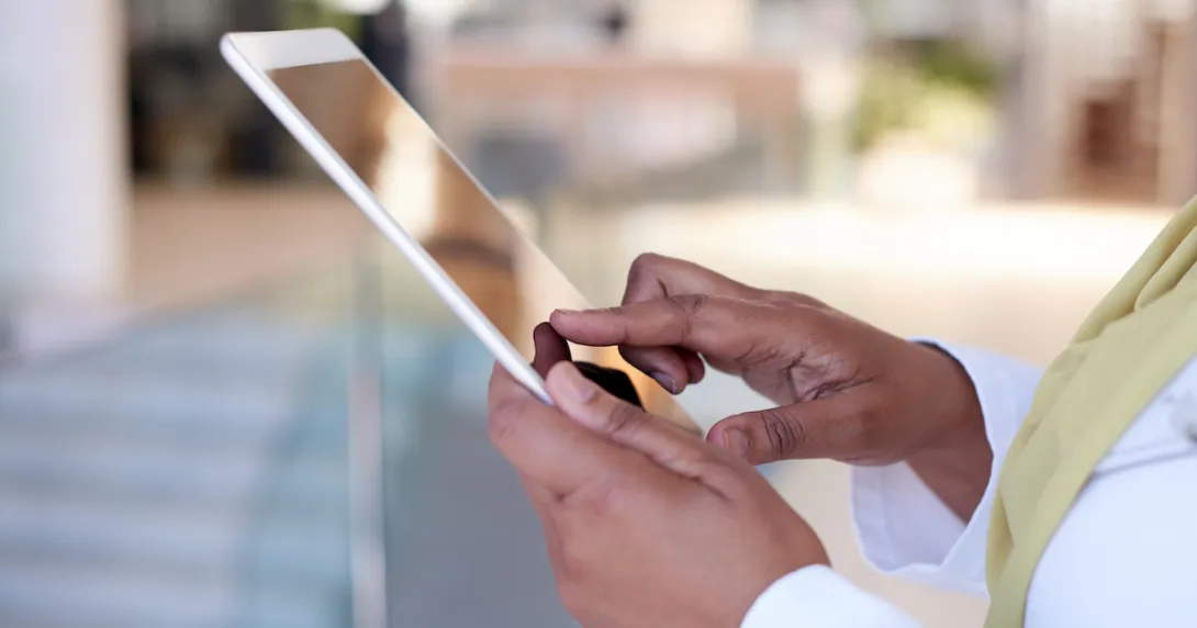 Someone holding a tablet near their torso