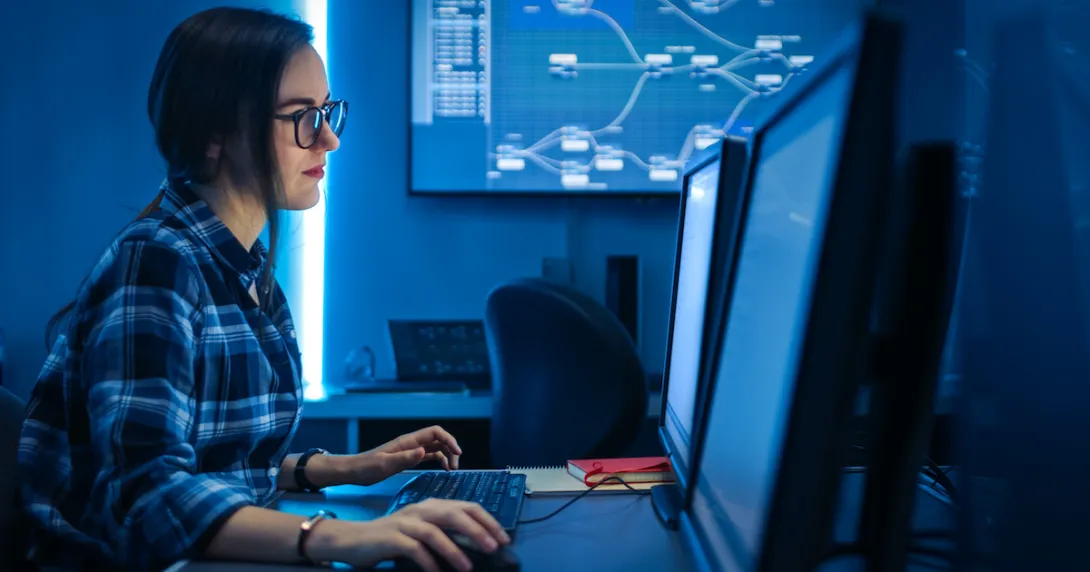 A computer programmer using a desktop computer