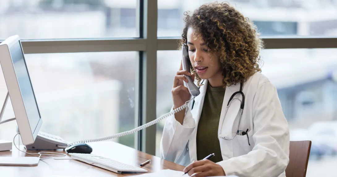 A doctor in a phone call consultation with a patient