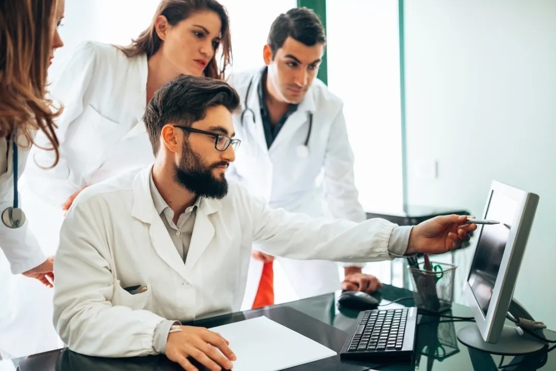 Healthcare practitioners looking at ultrasound results