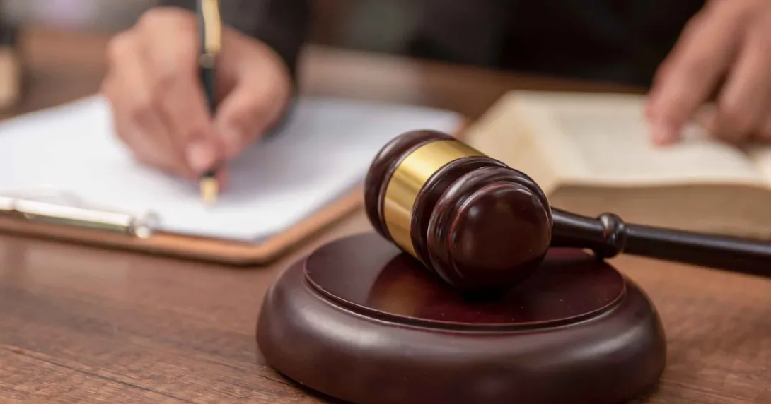 Judge signing a document in a courtroom