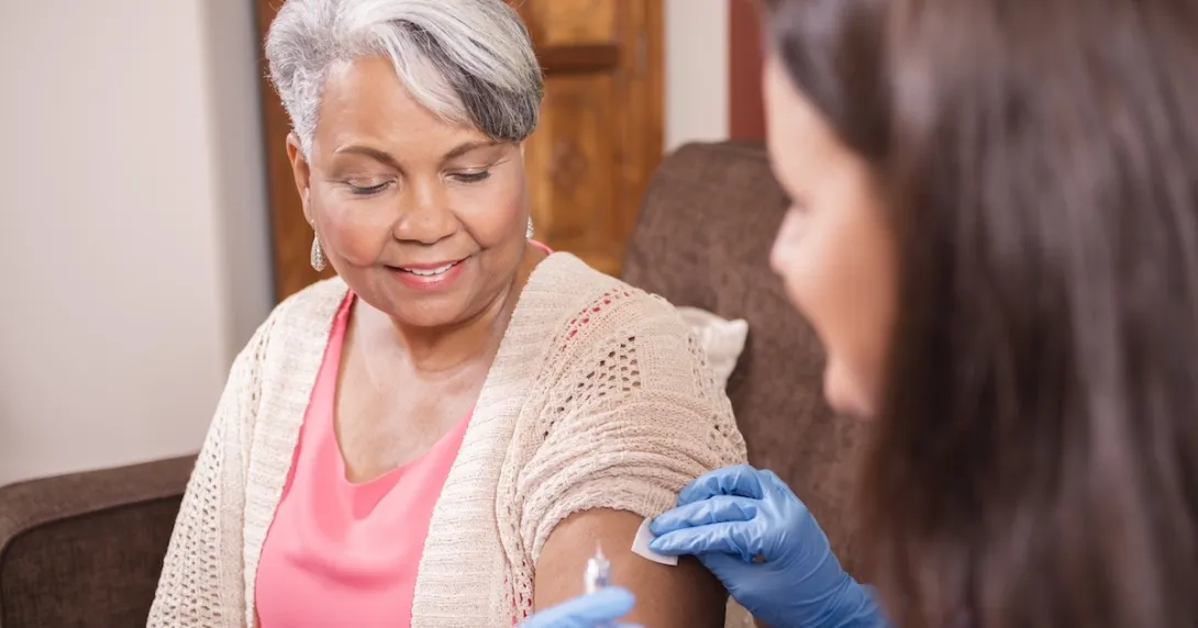 Health care professional administering an injectable medication