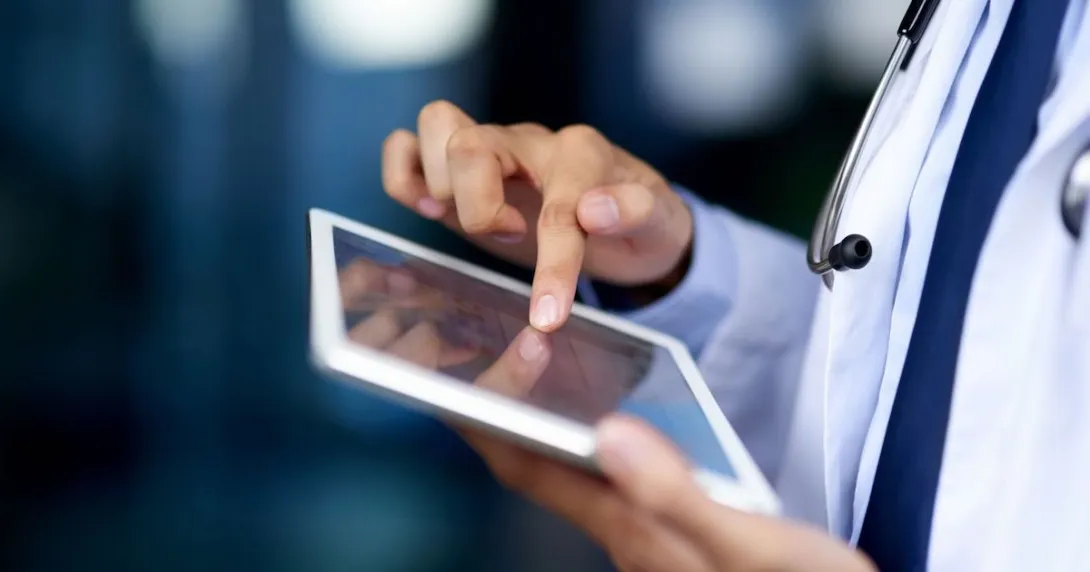 A close-up of a doctor using a tablet.