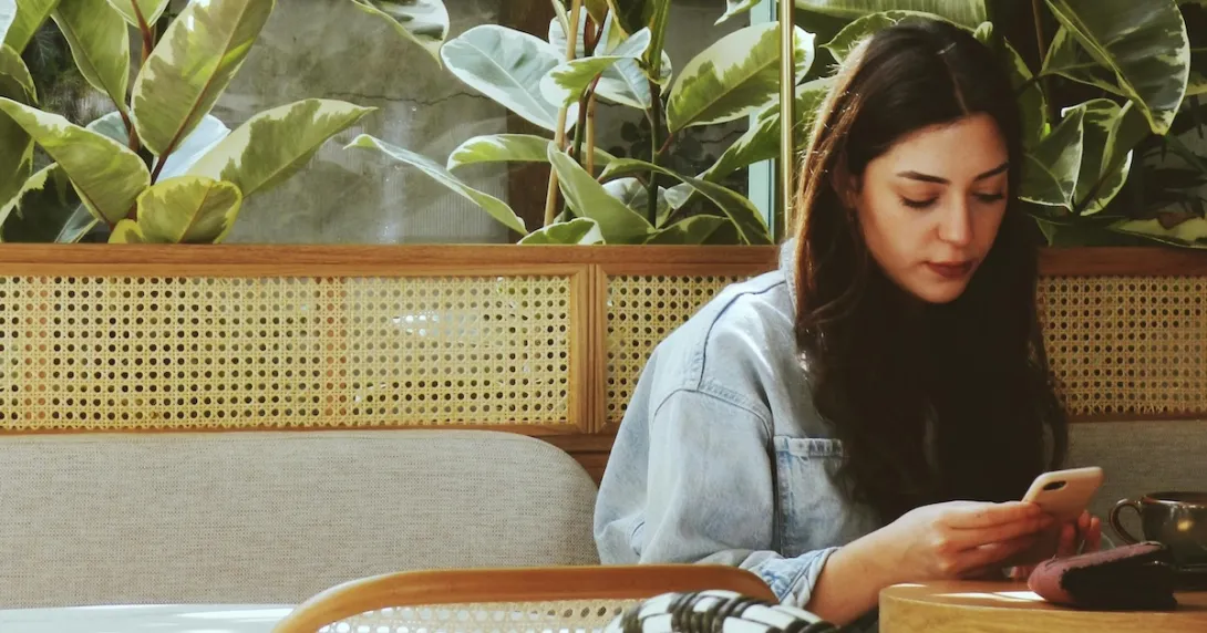 A young person using their smartphone