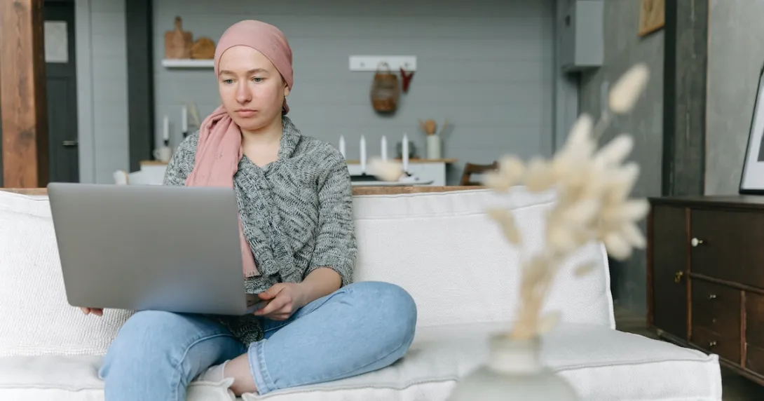 A cancer survivor using a laptop computer