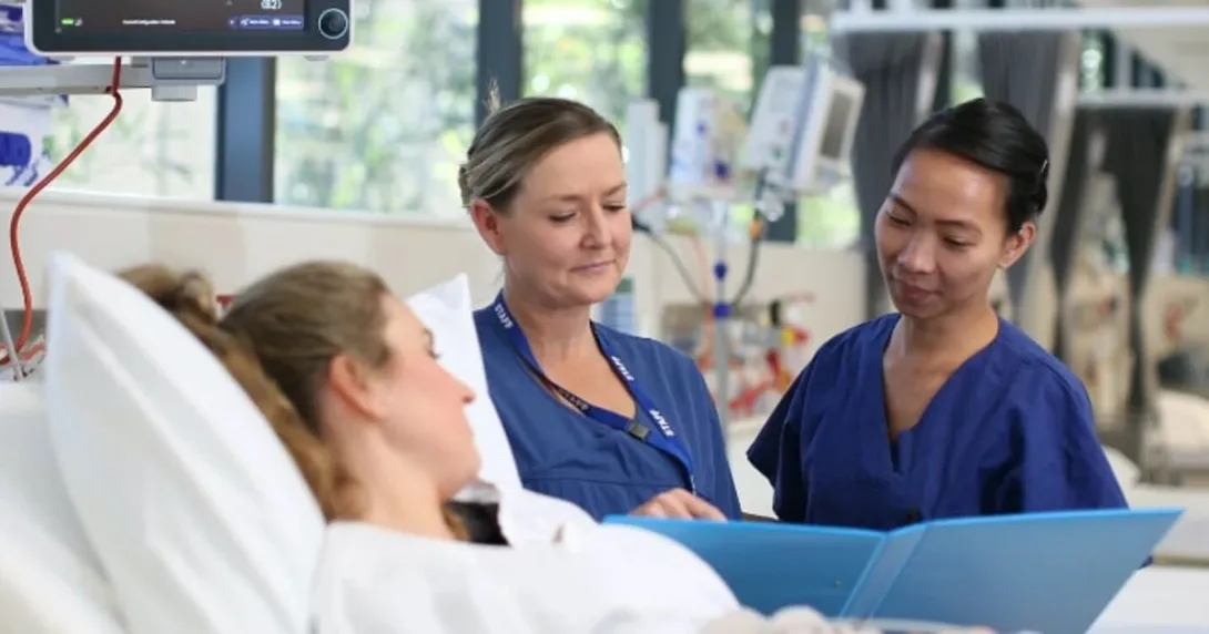 Virtus Health nurses assisting a patient in bed