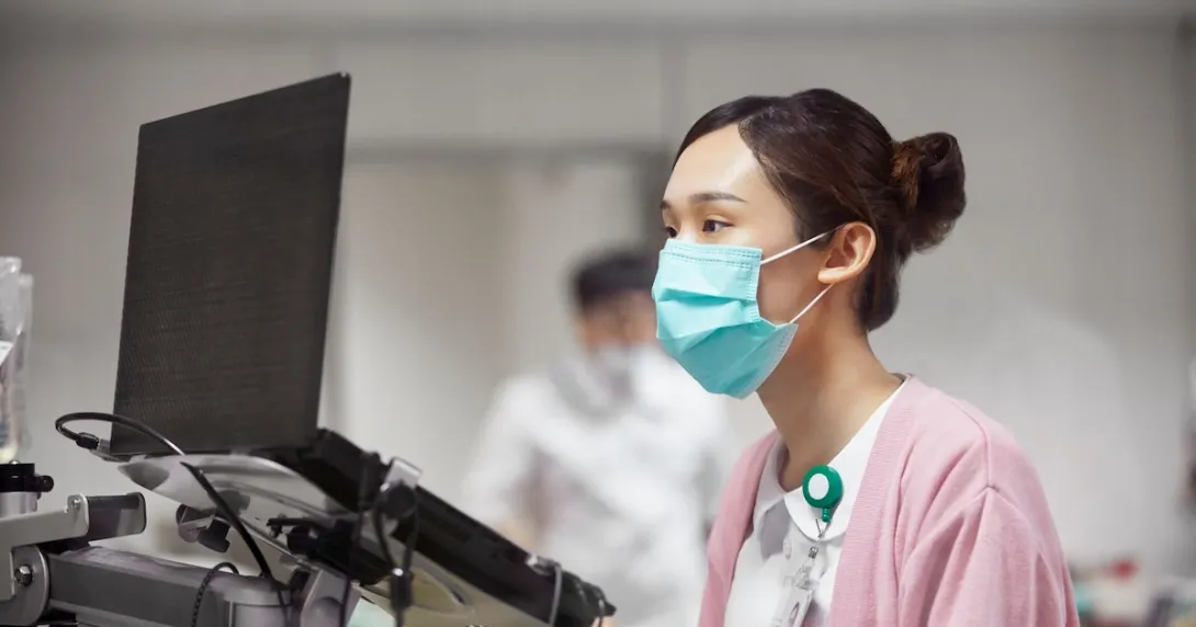 Healthcare professional looking at a computer