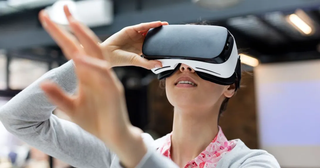 Person using a virtual reality headset while holding their hands up in front of them