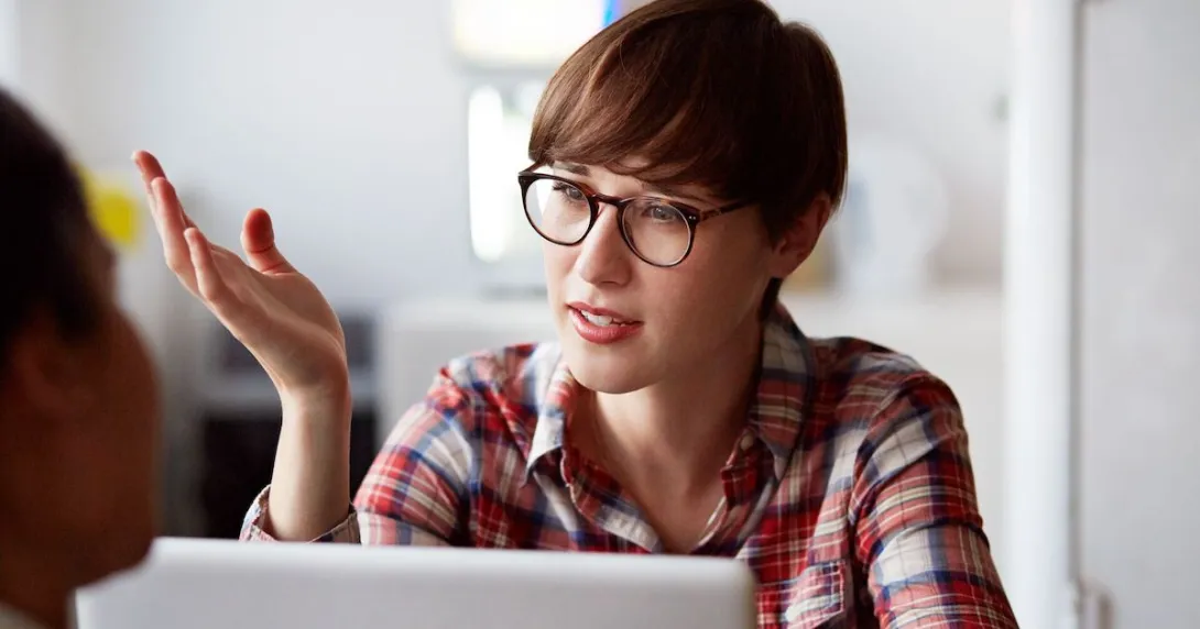 Person wearing glasses and sitting in front of a computer