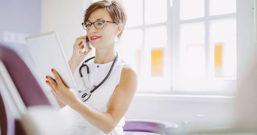 Healthcare provider in an office looking at a tablet