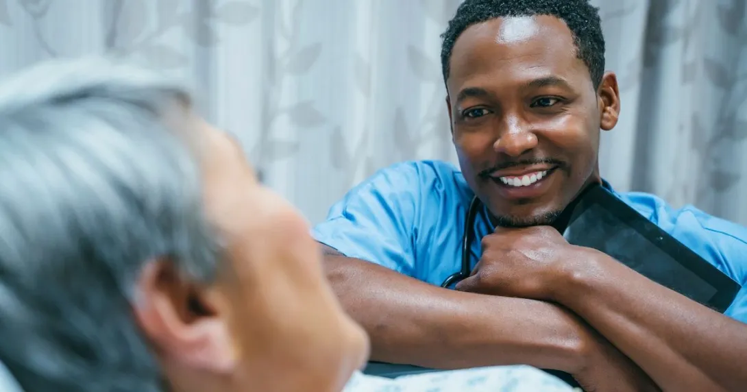 Healthcare provider speaking to a patient while smiling